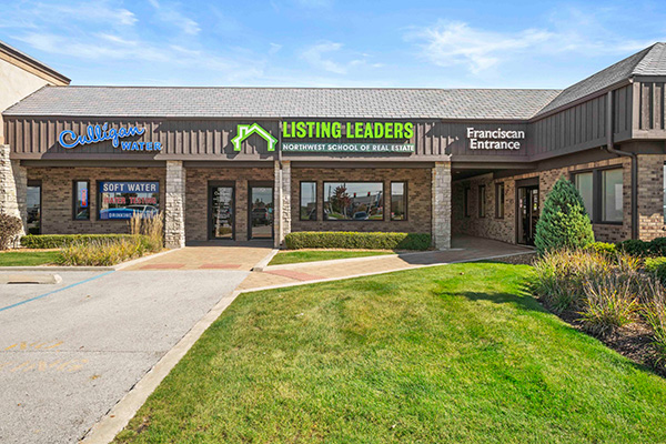 Front entrance of Listing Leaders Northwest School of Real Estate office building with visible signage.