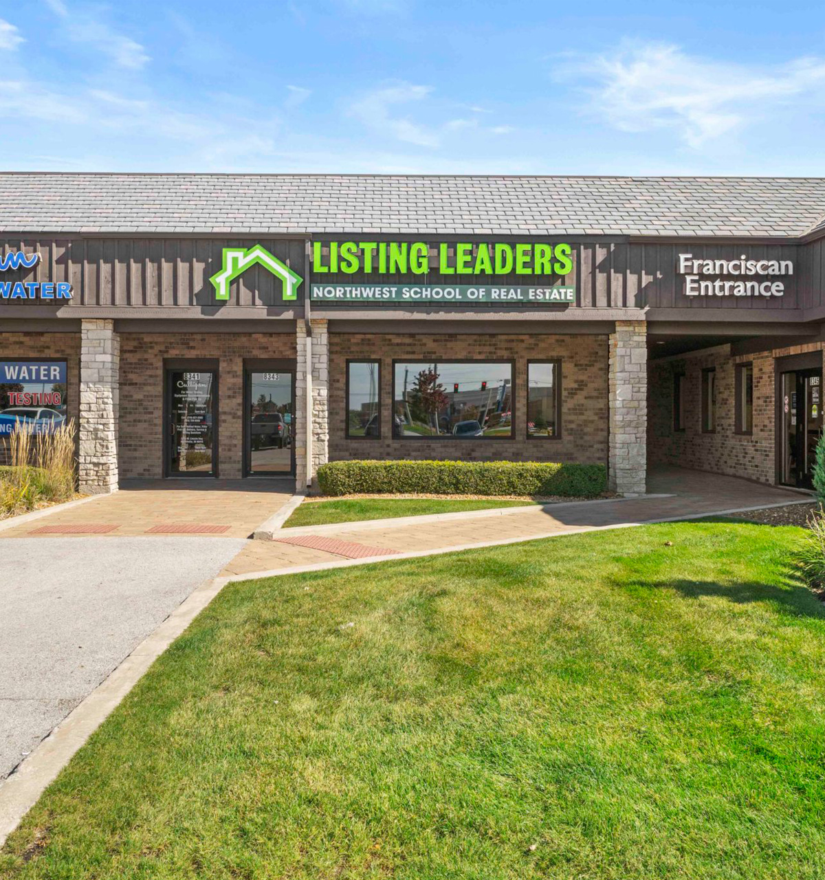 Listing Leaders Northwest School of Real Estate office exterior with bright green sign and landscaped entrance. Listing Leaders Northwest School of Real Estate office exterior with bright green sign and landscaped entrance.